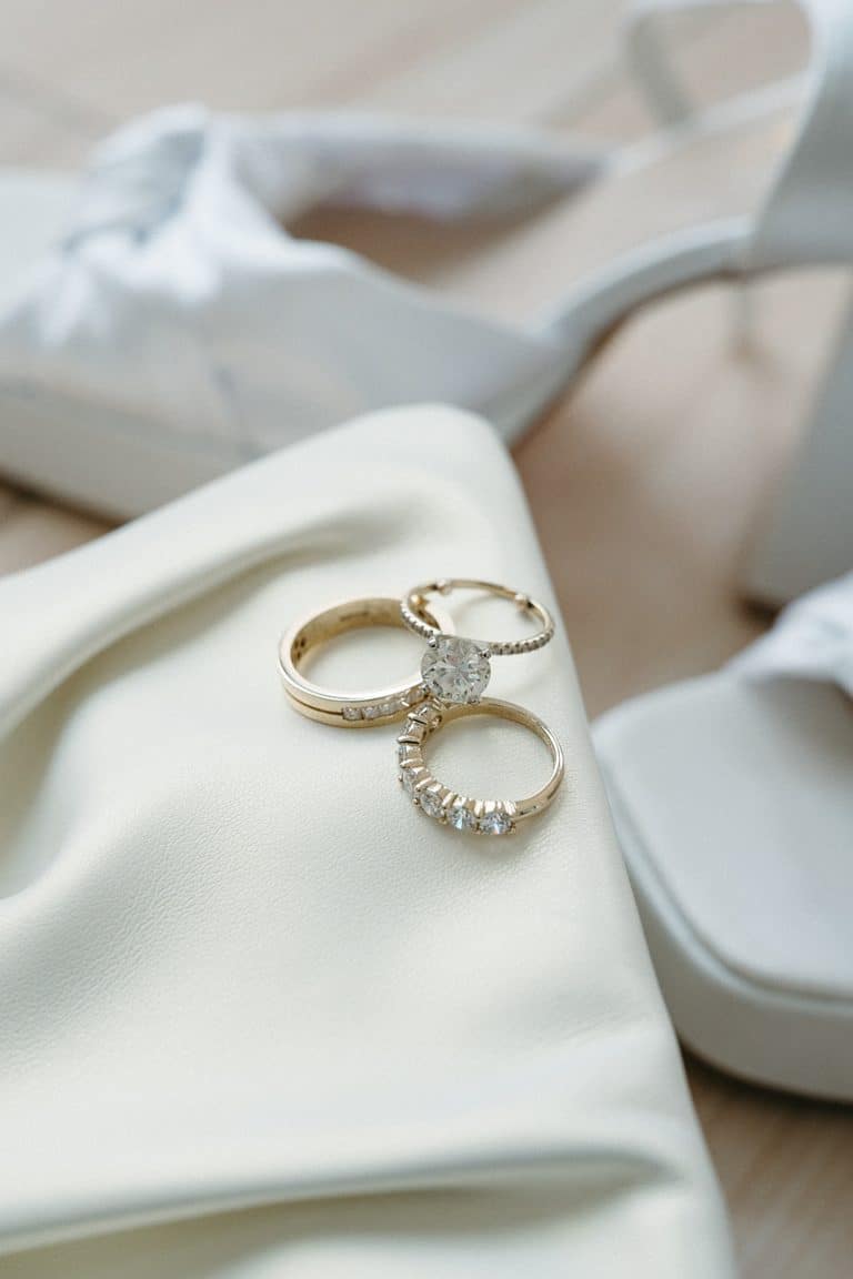 Wedding rings resting on soft ivory silk