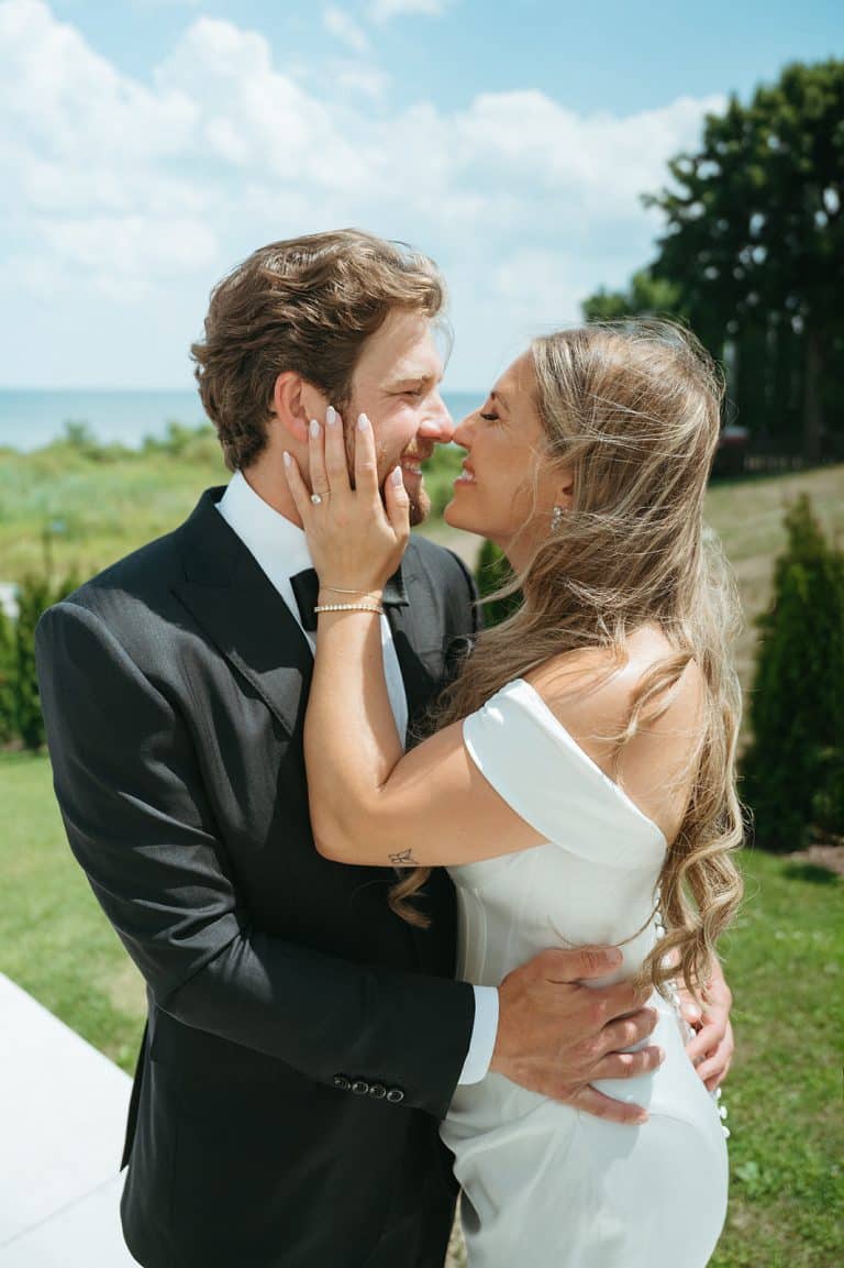 A bride and groom sharing a laugh in the garden