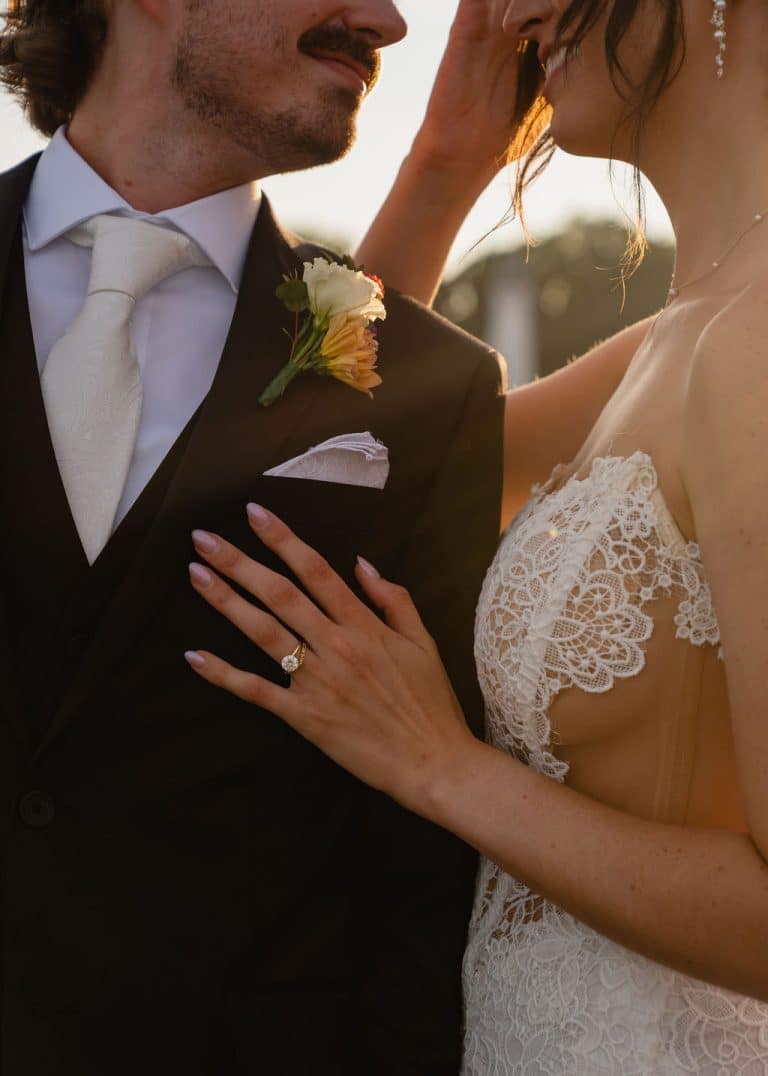 A bride's hand resting on her groom's lapel